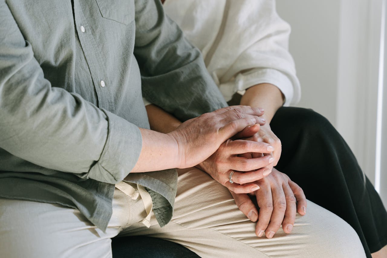 Close-up of a couple holding hands, symbolizing comfort and connection. A moment of intimacy and support.